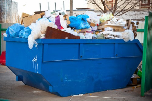 Business recycling bins labelled for dry, glass, food and WEEE streams